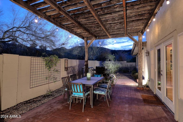 view of terrace featuring a pergola, a mountain view, and french doors