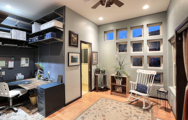 office space featuring ceiling fan and light wood-type flooring