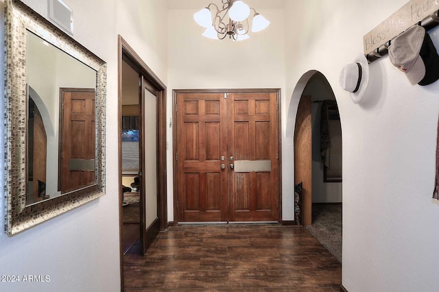 foyer entrance with a chandelier and dark hardwood / wood-style flooring