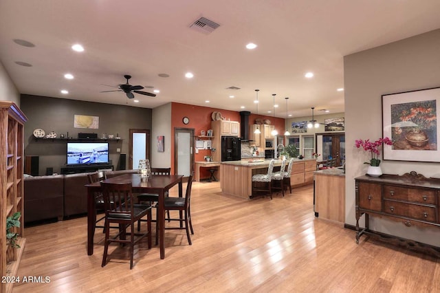 dining space featuring ceiling fan and light hardwood / wood-style floors