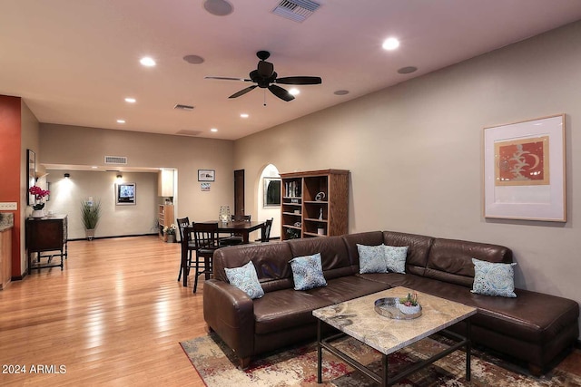 living room with light hardwood / wood-style floors and ceiling fan