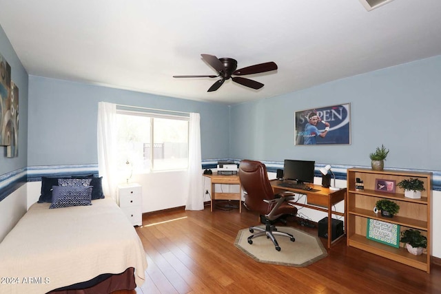 bedroom with ceiling fan and hardwood / wood-style flooring