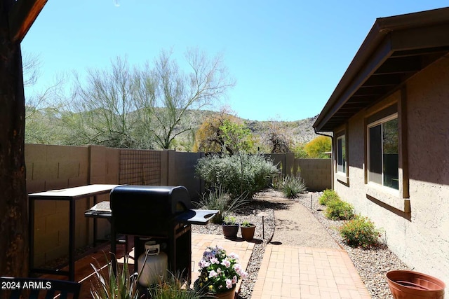 view of terrace with a mountain view and a grill