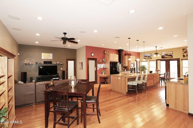 dining room featuring french doors, light hardwood / wood-style floors, and ceiling fan