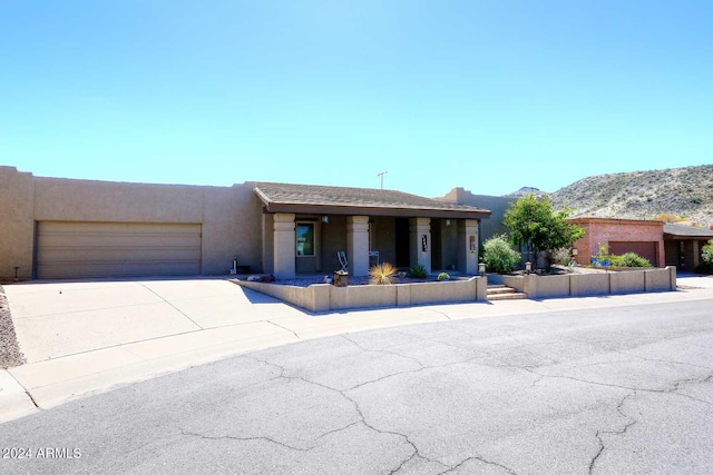 view of front of home with a mountain view and a garage