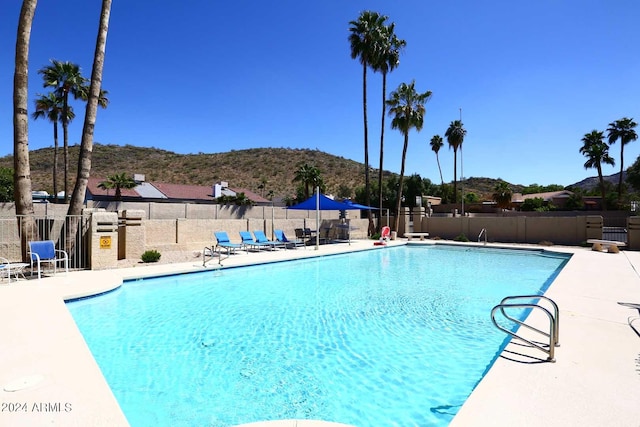 view of pool featuring a patio area and a mountain view