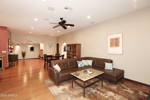 living room featuring ceiling fan and light hardwood / wood-style flooring