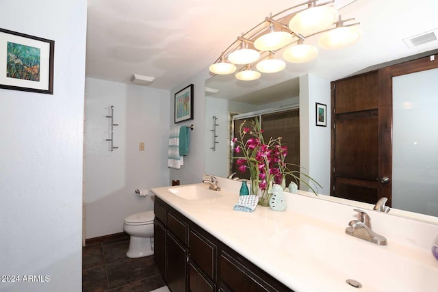 bathroom with toilet, tile floors, and dual vanity