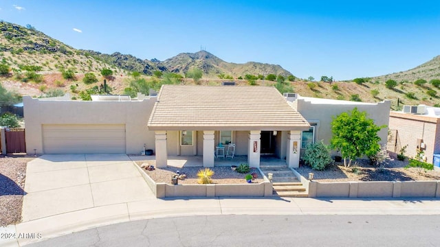 view of front of property featuring a mountain view and a garage