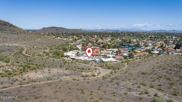 birds eye view of property featuring a mountain view