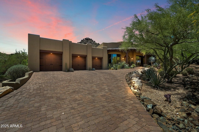 7731 E Soaring Eagle Way, Scottsdale, AZ 85266 - adobe home with an attached garage, decorative driveway, and stucco siding
