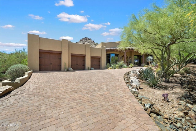 7731 E Soaring Eagle Way, Scottsdale, AZ 85266 - southwest-style home with stucco siding, an attached garage, and decorative driveway