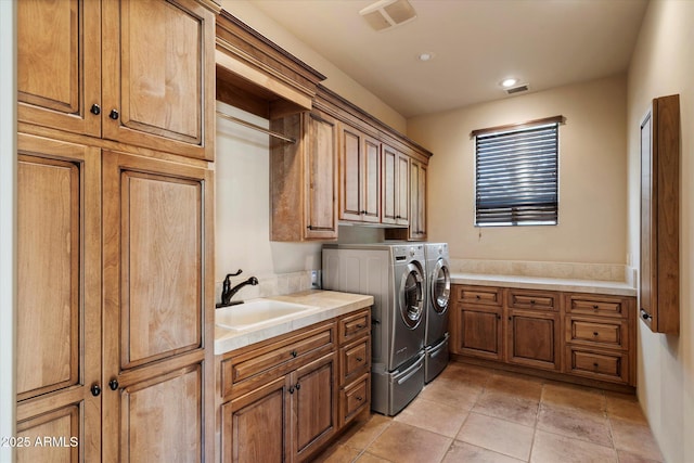 7731 E Soaring Eagle Way, Scottsdale, AZ 85266 - laundry room with cabinet space, washing machine and dryer, recessed lighting, and light tile patterned floors