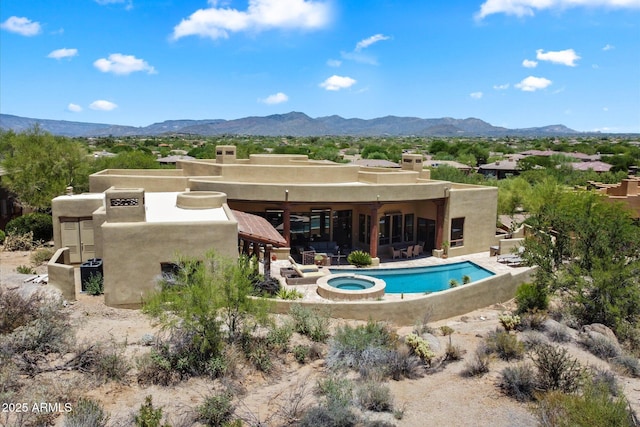 7731 E Soaring Eagle Way, Scottsdale, AZ 85266 - rear view of house with stucco siding, a mountain view, a patio area, and a pool with connected hot tub