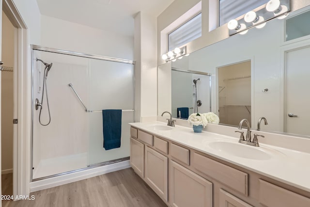 bathroom featuring an enclosed shower, vanity, and hardwood / wood-style floors