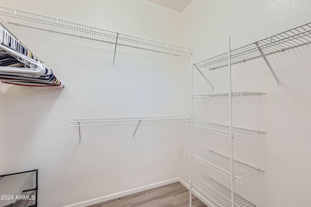 spacious closet featuring hardwood / wood-style floors