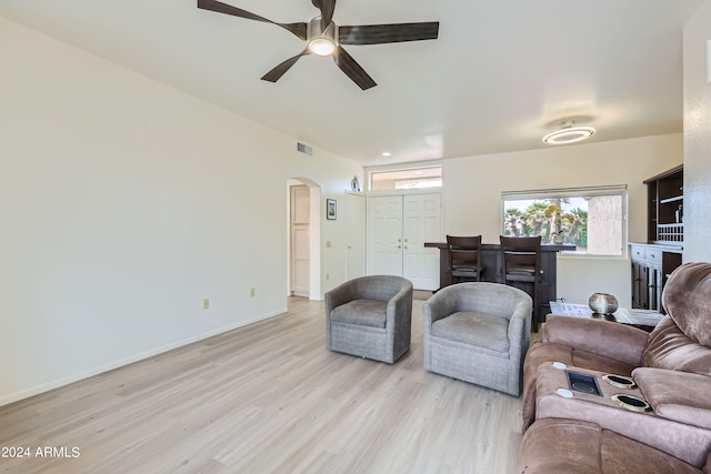 living room featuring ceiling fan and light hardwood / wood-style floors