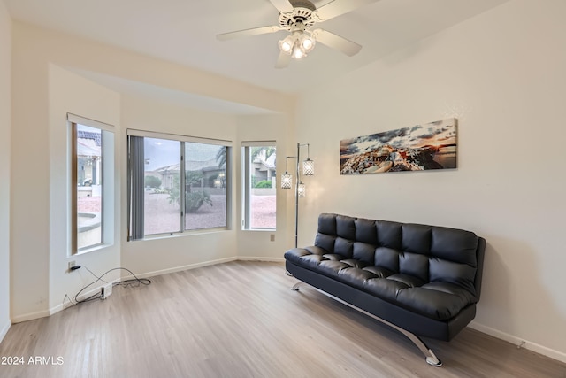 living area with ceiling fan and light wood-type flooring