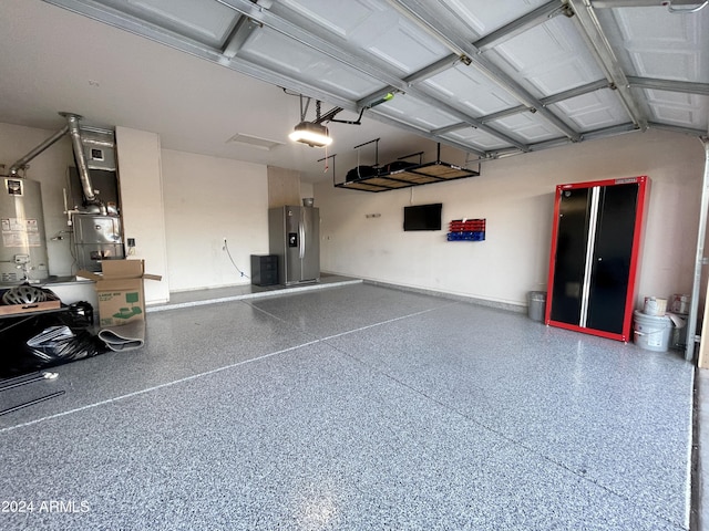 garage featuring stainless steel refrigerator with ice dispenser, water heater, and a garage door opener