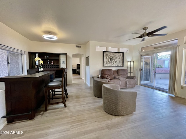 living room with ceiling fan and light hardwood / wood-style flooring