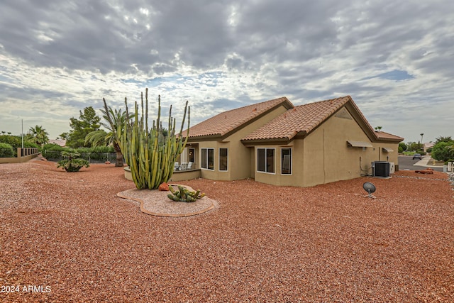 rear view of house featuring central AC