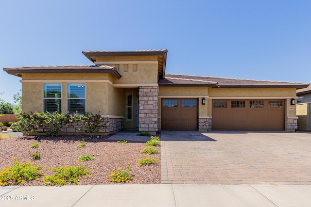 20603 W Alsap Rd, Buckeye, AZ 85396 - prairie-style house with an attached garage, stone siding, stucco siding, and decorative driveway
