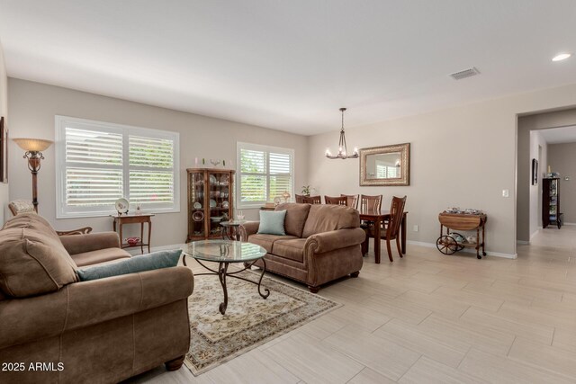 20603 W Alsap Rd, Buckeye, AZ 85396 - living room featuring a chandelier and baseboards