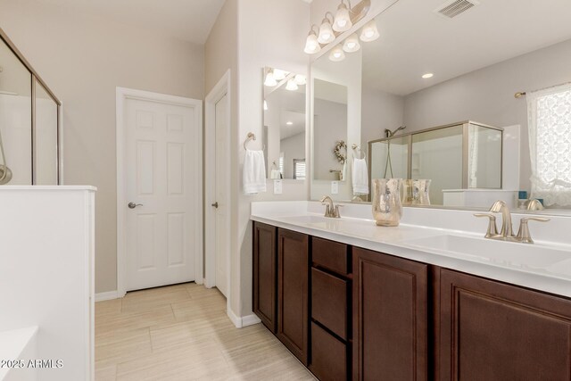 20603 W Alsap Rd, Buckeye, AZ 85396 - bathroom with a stall shower, double vanity, and baseboards