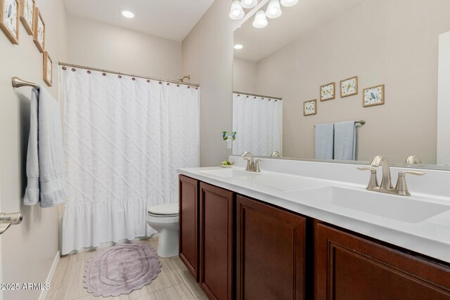 20603 W Alsap Rd, Buckeye, AZ 85396 - bathroom featuring toilet, double vanity, and a shower with shower curtain