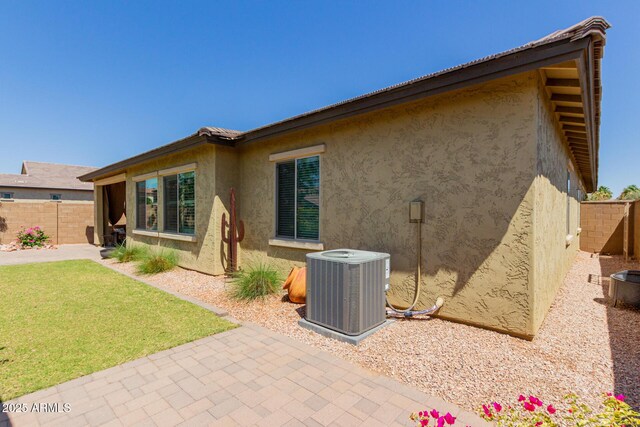 20603 W Alsap Rd, Buckeye, AZ 85396 - back of property featuring central AC, stucco siding, and a patio