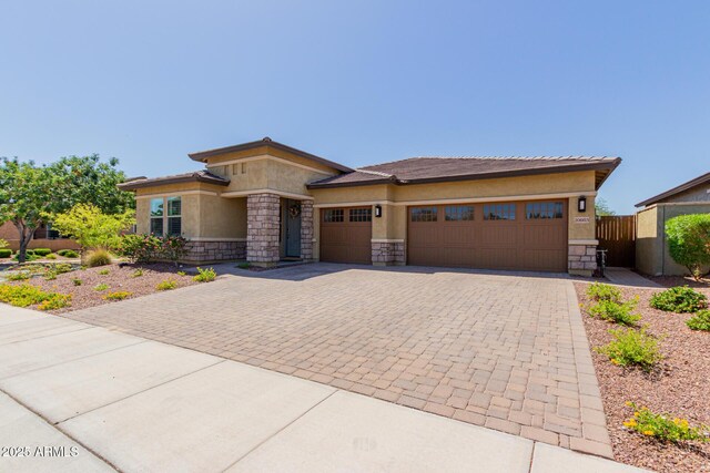 20603 W Alsap Rd, Buckeye, AZ 85396 - prairie-style house featuring stone siding, decorative driveway, stucco siding, and a garage