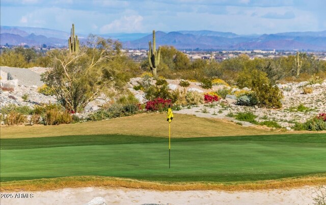 20603 W Alsap Rd, Buckeye, AZ 85396 - view of property's community with golf course view, a mountain view, a putting area, and a lawn