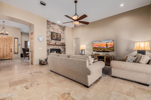 38106 N 2nd Ln, Phoenix, AZ 85086 - living area featuring arched walkways, ceiling fan, a stone fireplace, recessed lighting, and a chandelier