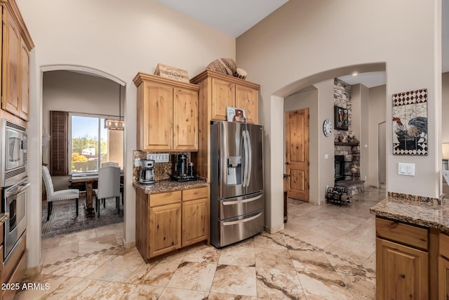 38106 N 2nd Ln, Phoenix, AZ 85086 - kitchen featuring stainless steel appliances, a high ceiling, dark stone countertops, and arched walkways