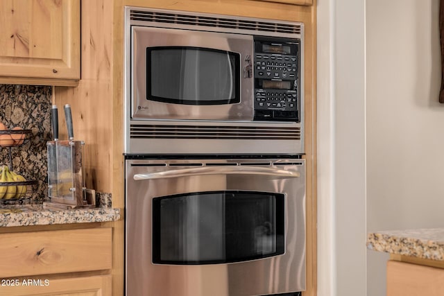 38106 N 2nd Ln, Phoenix, AZ 85086 - kitchen view of appliances with stainless steel finishes, light stone counters, light brown cabinets, and decorative backsplash