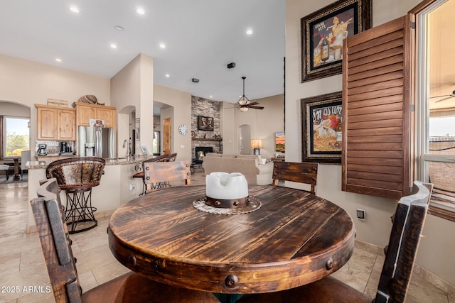 38106 N 2nd Ln, Phoenix, AZ 85086 - dining area with arched walkways, ceiling fan, recessed lighting, a fireplace, and stone tile floors