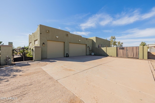 38106 N 2nd Ln, Phoenix, AZ 85086 - view of property exterior with a gate, concrete driveway, an attached garage, and stucco siding