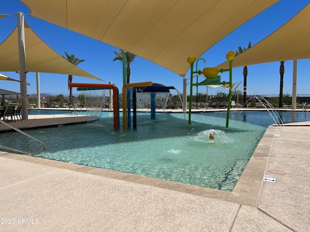 view of swimming pool with pool water feature