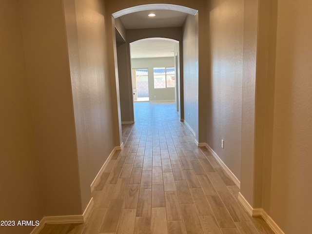 corridor with light hardwood / wood-style flooring