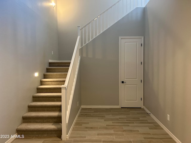 stairway with hardwood / wood-style flooring