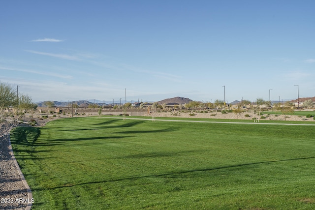 view of nearby features featuring a mountain view and a yard