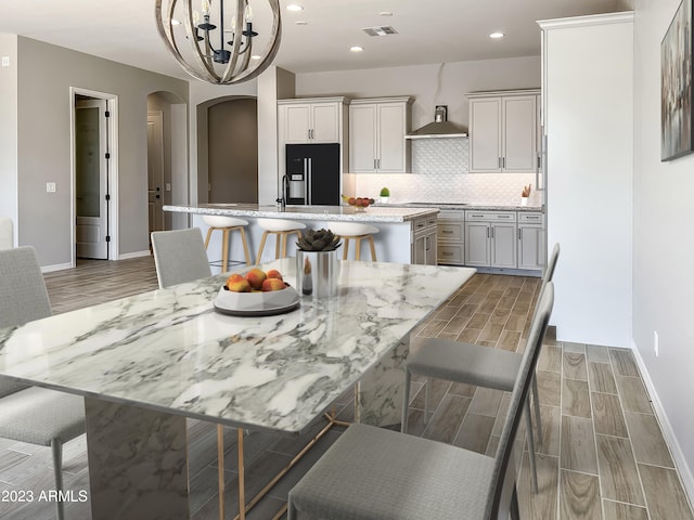 dining space with dark wood-type flooring and a notable chandelier