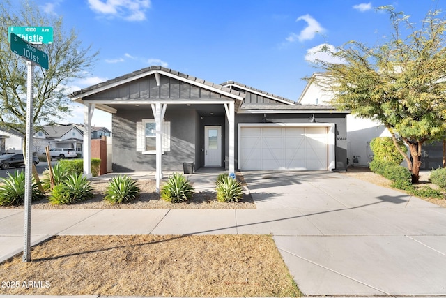 view of front of home featuring stucco siding, an attached garage, and concrete driveway