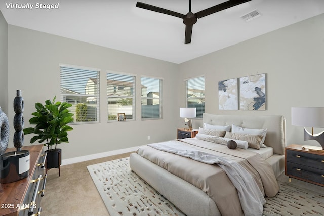 bedroom featuring visible vents, light carpet, baseboards, and a ceiling fan