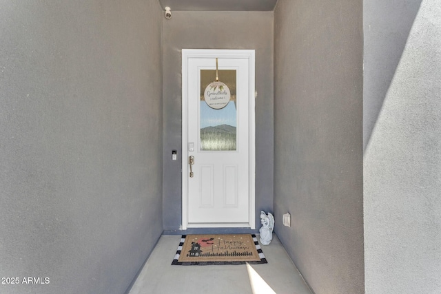 entrance to property with stucco siding