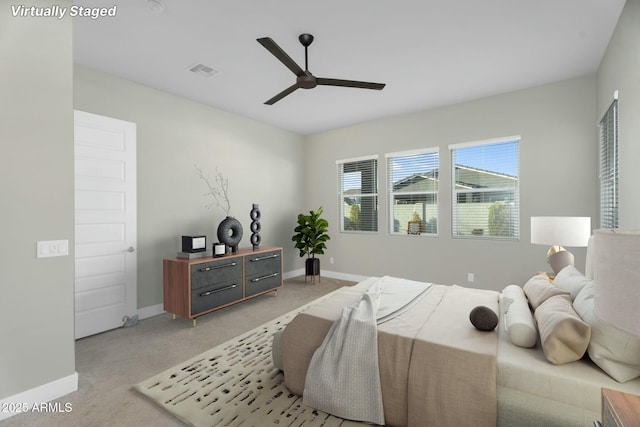 bedroom with light carpet, visible vents, a ceiling fan, and baseboards