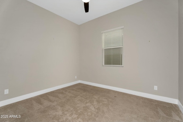 spare room featuring carpet, a ceiling fan, and baseboards