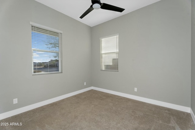 spare room featuring baseboards, a ceiling fan, and carpet floors