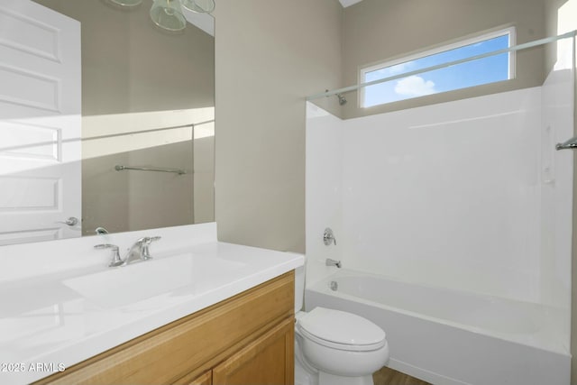 full bathroom featuring vanity, bathing tub / shower combination, and toilet