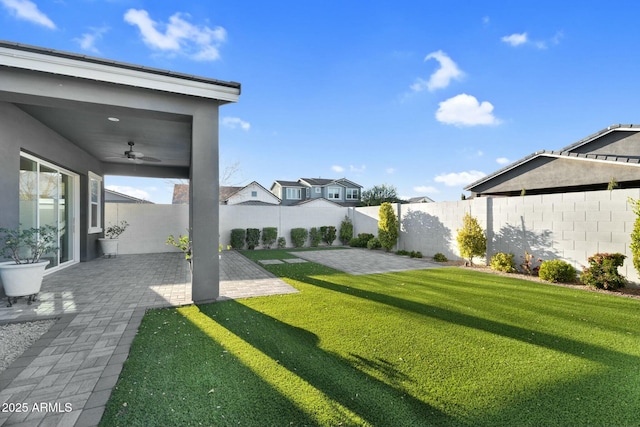 view of yard featuring a ceiling fan, a patio area, and a fenced backyard